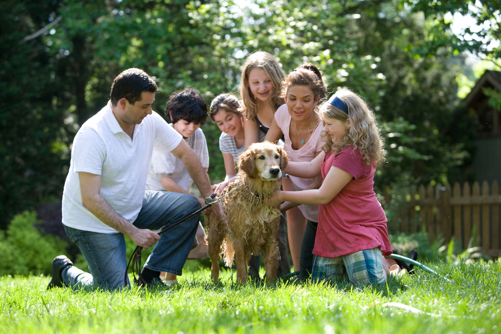family petting a dog